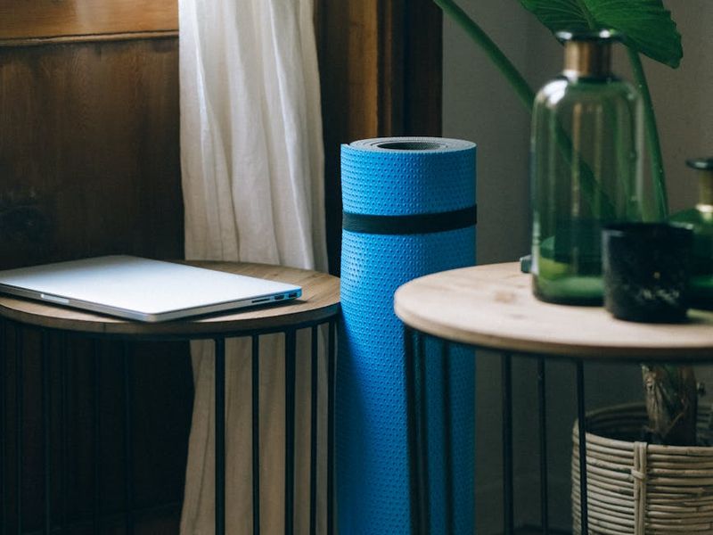 Spacious minimalist room with a yoga mat on the floor.
